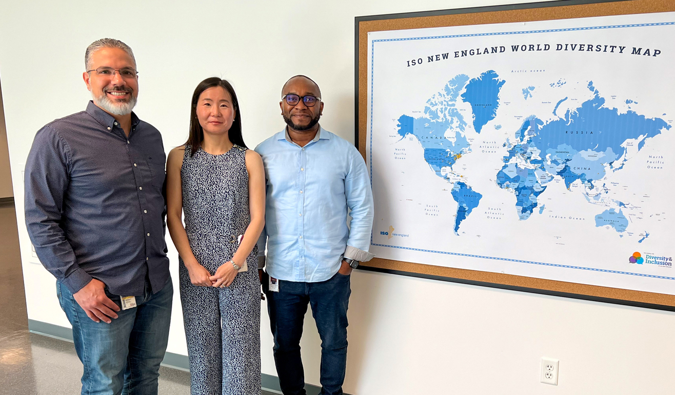 ISO staff in front of World Diversity Map